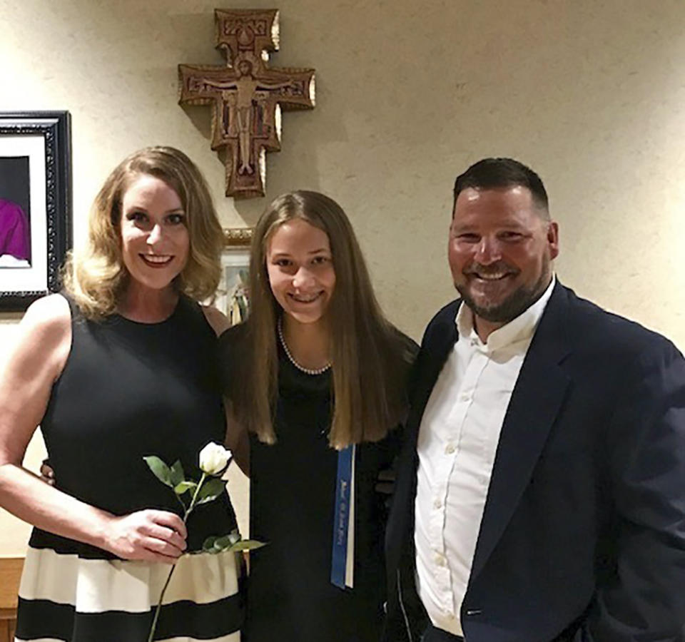 In this image provided by Garrett Law, Barbara and Bobby Barrick pose with their daughter. Barbara Barrick, the widow of Bobby Barrick, sued the sheriff and other officials in McCurtain County, Okla., Thursday, April 20, 2023, alleging deputies and a state game warden violated her husband's constitutional right and used excessive force during his arrest. He died days later. The suit came as national attention has been drawn to the rural county by a recording of the sheriff and other local officials discussing killing journalists who were reporting on Barrick’s death. (Garrett Law via AP)