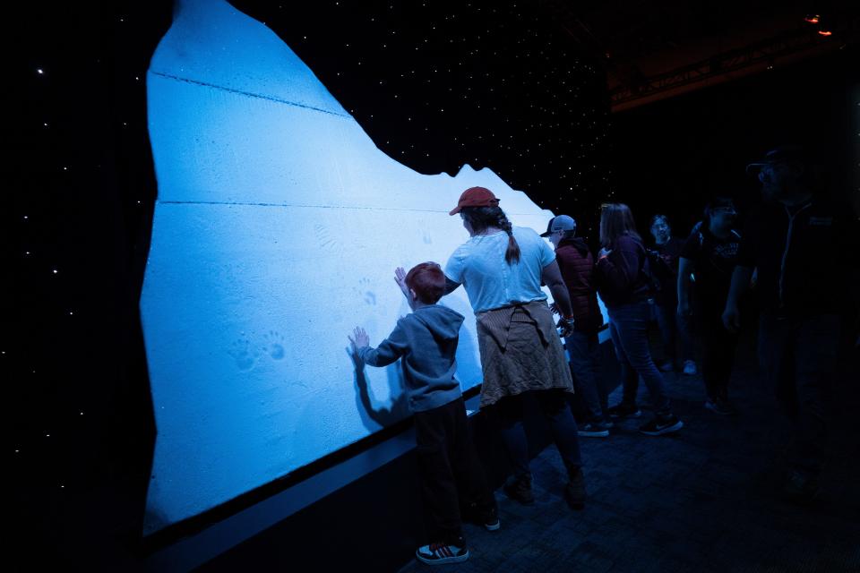 Visitors to “Titanic: The Artifact Exhibition" at COSI examine a replica of the iceberg that took down the ship in 1912. The exhibition opened on March 9 and continues through Sept. 2.