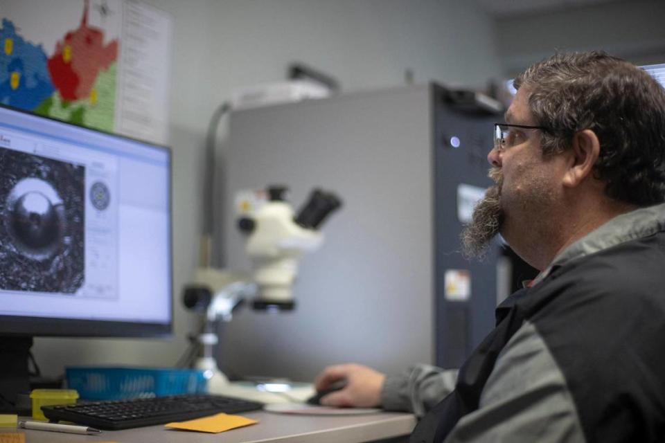 Kevin “Chip” Chipley, Appalachia High Intensity Drug Trafficking Area criminal intelligence analyst, looks at the image of a casing at the task force’s offices in London, Ky., on Wednesday, April 5, 2023.