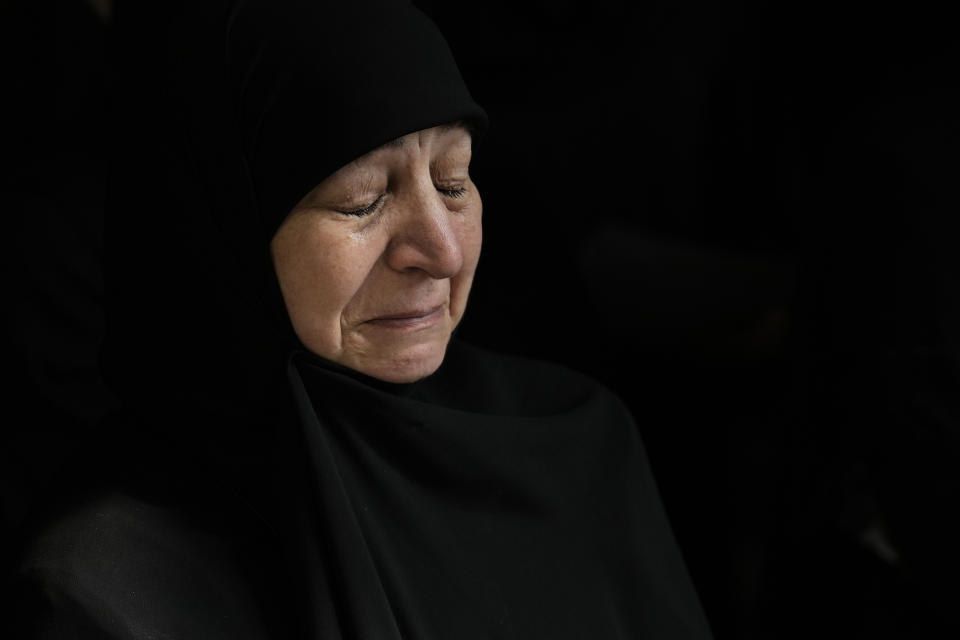 A woman weeps during the funeral procession of, Ali Ahmad Hussein, who was killed by an Israeli strike in south Lebanon, in the southern Beirut suburb of Dahiyeh, Lebanon, Monday, April 8, 2024. Israel's military says it has killed a commander of Hezbollah's secretive Radwan Force in southern Lebanon. (AP Photo/Bilal Hussein)
