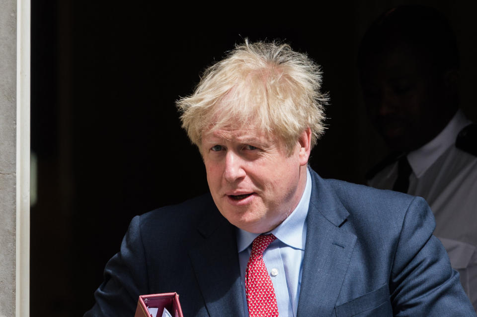 U.K. Prime Minister Boris Johnson leaves 10 Downing Street on July 15, 2020. On Friday, Johnson suggested that coronavirus restrictions could largely be gone by Christmas. (Photo: Barcroft Media via Getty Images)