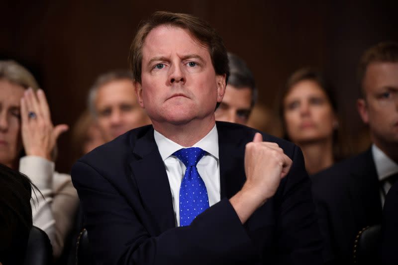 FILE PHOTO: White House Counsel Don McGahn listens to Supreme Court nominee Brett Kavanaugh as he testifies before the US Senate Judiciary Committee on Capitol Hill in Washington