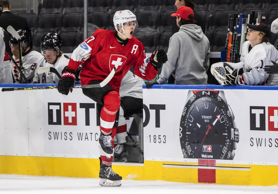 Switzerland's Attilio Biasca (17) celebrates a goal against Austria during the third period of an IIHF world junior hockey championships game Monday, Aug. 15, 2022, in Edmonton, Alberta. (Jason Franson/The Canadian Press via AP)