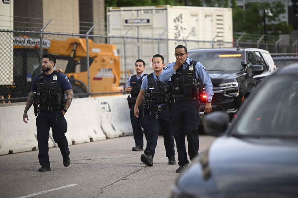 Members of law enforcement gather outside Hennepin County Medical Center in Minneapolis, Thursday, May 30, 2024, following a fatal shooting.(Aaron Lavinsky/Star Tribune via AP)