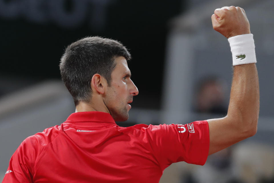 Serbia's Novak Djokovic clenches his fist after scoring a point against Greece's Stefanos Tsitsipas in the semifinal match of the French Open tennis tournament at the Roland Garros stadium in Paris, France, Friday, Oct. 9, 2020. (AP Photo/Michel Euler)