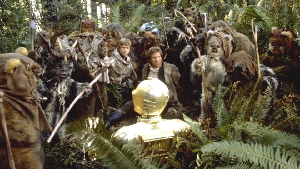 Ewoks surround Han Solo and Luke Skywalker in Return of the Jedi