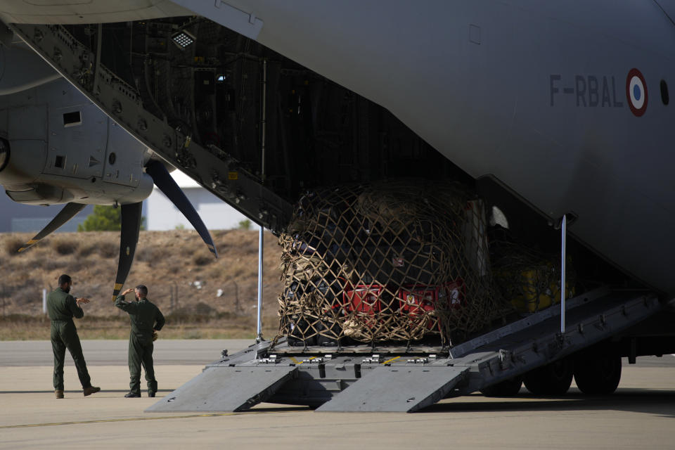 Soldiers stand by a cargo plane loaded with disaster relief for Libya, Wednesday, Sept. 13, 2023 at the Istres military base, southern France. A Libyan local health official said the toll in Libya has reached more than 5,100 dead and is expected to rise further in the eastern city of Derna where floods caused massive devastation over the weekend. French government' s spokesman said a French rescue team of about 50 people aim at being "operational within 48 hours" in Libya. (AP Photo/Daniel Cole)