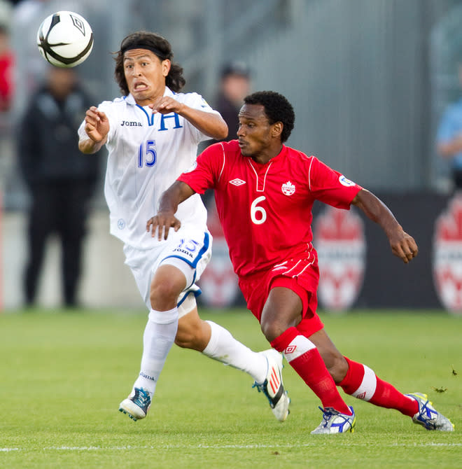 Roger Espinoza (L) of Honduras and Julian De Guzman of Canada fight for the ball during their FIFA 2014 World Cup Qualifier at BMO field in Toronto, Ontario, June 12, 2012. AFP PHOTO/Geoff RobinsGEOFF ROBINS/AFP/GettyImages