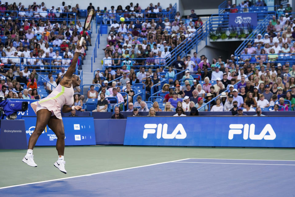 Serena Williams, of the United States, serves to Emma Raducanu, of Britain, during the Western & Southern Open tennis tournament Tuesday, Aug. 16, 2022, in Mason, Ohio. (AP Photo/Jeff Dean)