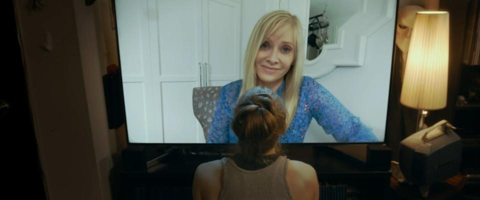 Emily Bennett (bottom) can't escape her apartment or a video chat with her overbearing mom (Barbara Crampton) in the horror film "Alone With You."