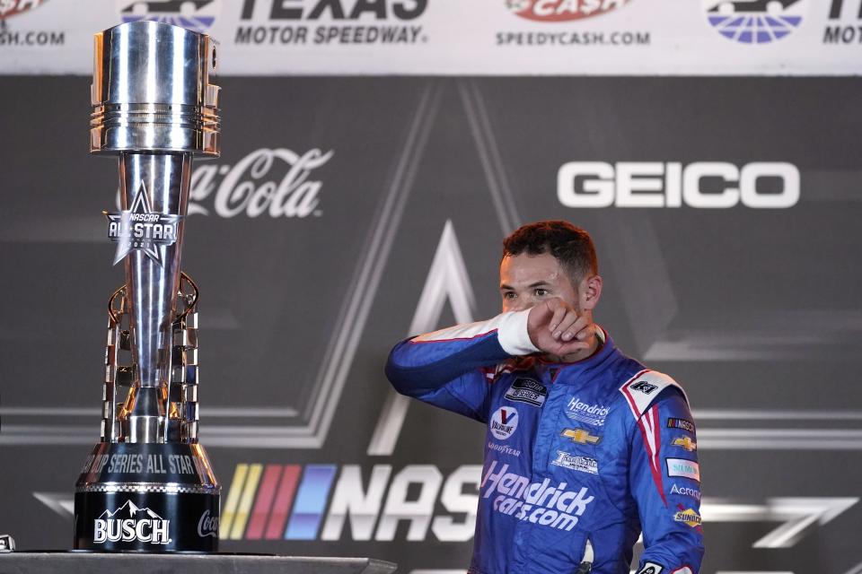 Kyle Larson stands in Victory Lane by the trophy after winning the NASCAR Cup Series All-Star auto race at Texas Motor Speedway in Fort Worth, Texas, Sunday, June 13, 2021. (AP Photo/Tony Gutierrez)