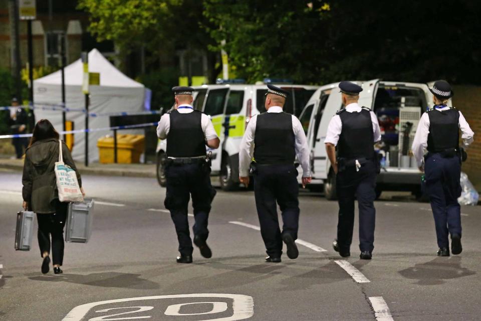 Police and Forensic Officers in Brecknock Road after the man was stabbed to death: NIGEL HOWARD ©