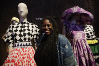 Fashion designer Abrima Erwia smiles as she poses with creations part of the Studio 189 women's Fall-Winter 2020-2021 collection, that was presented in Milan, Italy, Wednesday, Feb. 19, 2020. Italy's Chamber of fashion dedicate at a space at a fashion hub, to a selection of young African brands belonging to a new generation of designers embodying the powerful identity of African fashion. (AP Photo/Luca Bruno)