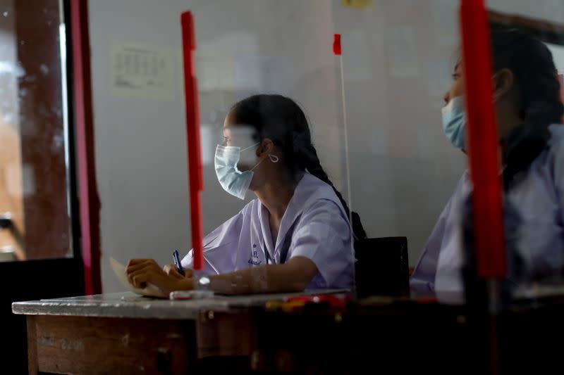 Girls wearing masks to prevent the spread of the coronavirus disease (COVID-19) are seen in a classroom of a school in Bangkok