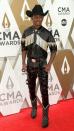 <p>Attending the CMA Awards in Nashville, wearing a monochromatic ensemble with silver fringe embellishments.</p>