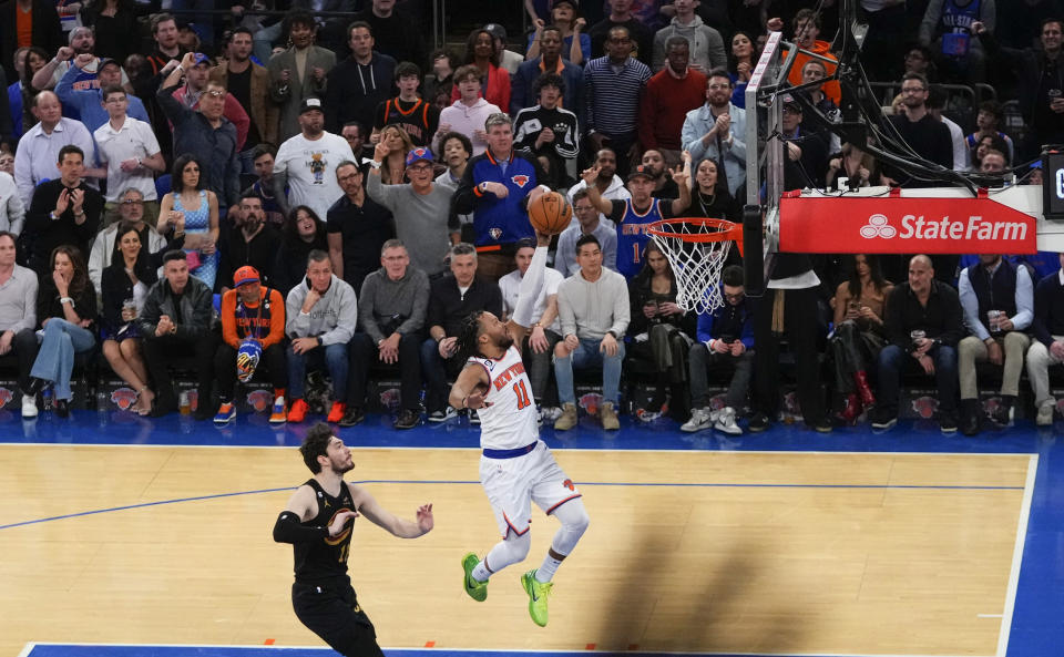 New York Knicks' Jalen Brunson (11) drives past Cleveland Cavaliers' Cedi Osman during the first half of Game 3 in an NBA basketball first-round playoff series Friday, April 21, 2023, in New York. (AP Photo/Frank Franklin II)