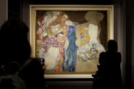 People admire Gustav Klimt's oil on canvas painting "The Bride" (1918) on display at the exhibition "Klimt. The Secession and Italy" at the Museum of Rome, in Palazzo Braschi, Rome, during a press preview, Tuesday, Oct. 26, 2021. The exhibition, that explores Klimt's period in Italy, will be open to visitors from Oct.27, 2021 to March 27, 2022. (AP Photo/Andrew Medichini)