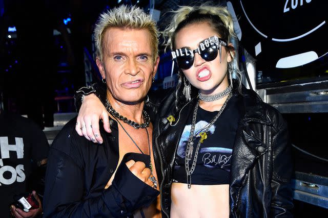 <p>Kevin Mazur/Wireimage</p> Billy Idol and Miley Cyrus pose backstage at the iHeartRadio Music Festival in Las Vegas in September 2016