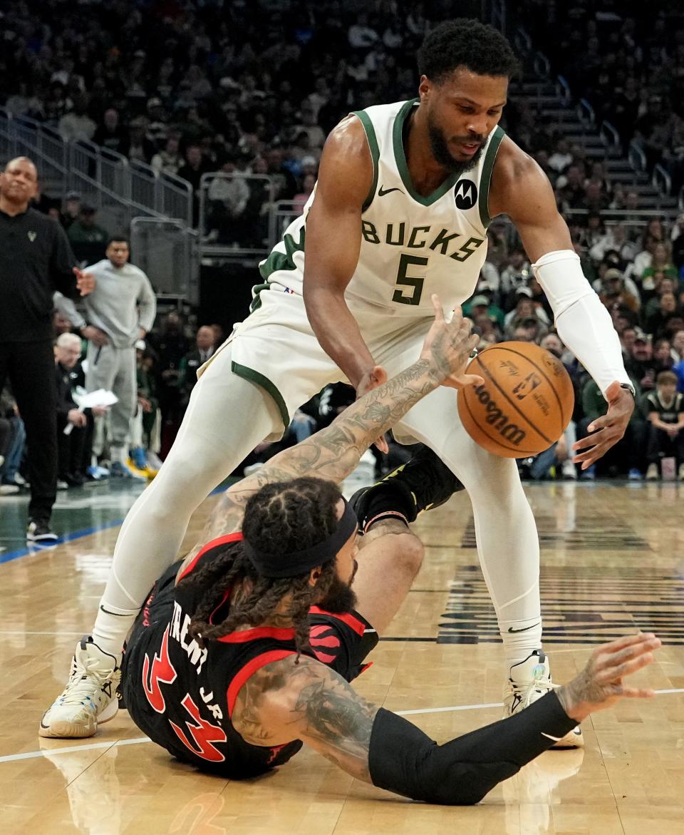 Raptors guard Gary Trent Jr. tries to steal the ball from Bucks guard Malik Beasley during the first half Friday night at Fiserv Forum.