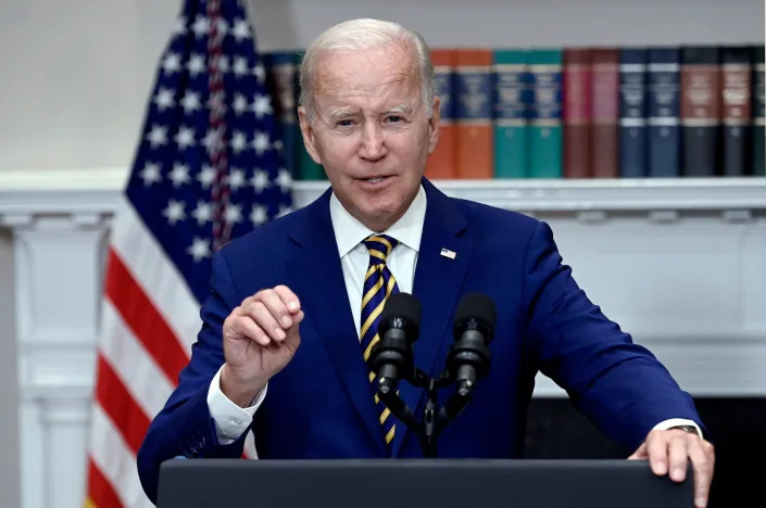 President Biden speaking from behind a podium.