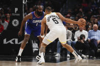 Los Angeles Clippers guard James Harden (1) defends against Utah Jazz guard Talen Horton-Tucker (5) during the first half of an NBA basketball game Friday, April 5, 2024, in Los Angeles. (AP Photo/Etienne Laurent)