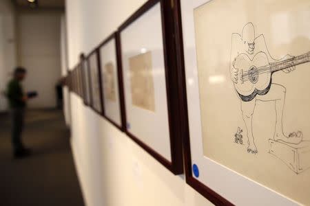 An untitled drawing of a four-eyed guitar player by John Lennon is seen during the press preview of a collection of Lennon's original drawings and manuscripts from 1964-65 at Sotheby's auction house in New York May 29, 2014. REUTERS/Shannon Stapleton