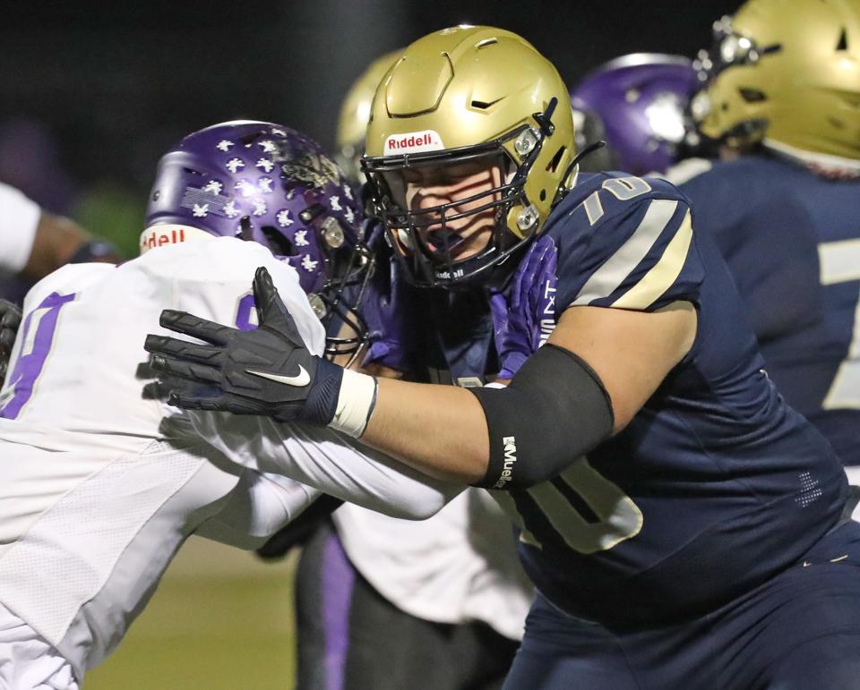 Hoban offensive lineman Sam Greer (right) blocks Barberton linebacker Micryn Miller in a Division II regional quarterfinal, Friday, Nov. 3, 2023.