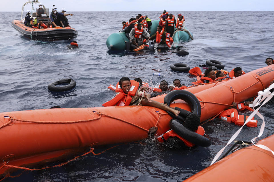 FILE - Migrants aboard a rubber boat end up in the water while others cling on to a centifloat before being rescued by a team of the Sea Watch-3, around 35 miles away from Libya, in Libyan SAR zone, Monday, Oct. 18, 2021. At a summit on Feb. 9-10, 2023, the EU's 27 heads of state and government are set to emphasise the importance of beefing up borders and pressuring the often-impoverished countries that people leave or cross to get to Europe, according to a draft statement prepared for the meeting. (AP Photo/Valeria Mongelli, File)