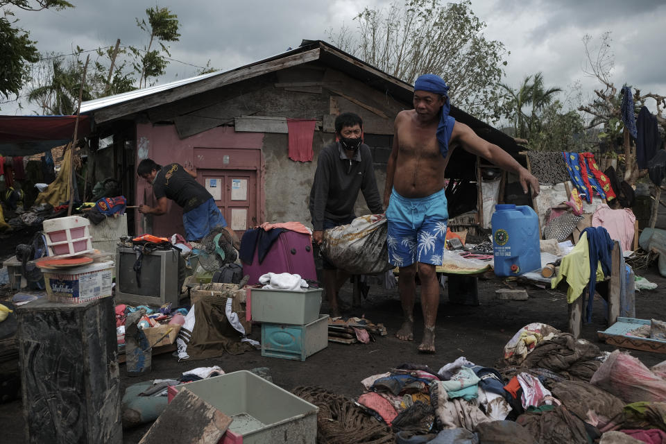 Residents try to save what's left of their belongings after heavy rains from Typhoon Goni washed down boulders and mudflows from Mayon Volcano, engulfing about 150 houses in a single community in the town of Guinobatan, Albay province, central Philippines on Monday, Nov. 2, 2020. More than a dozen of people were killed as Typhoon Goni lashed the Philippines over the weekend, and about 13,000 shanties and houses were damaged or swept away in the eastern island province that was first hit by the ferocious storm, officials said Monday. (AP Photo/John Michael Magdasoc)