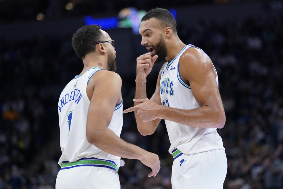 Minnesota Timberwolves forward Kyle Anderson (1) and center Rudy Gobert (27) talk during the first half of an NBA basketball game against the New Orleans Pelicans, Wednesday, Nov. 8, 2023, in Minneapolis. (AP Photo/Abbie Parr)