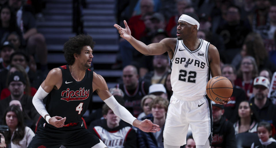 San Antonio Spurs guard Malaki Branham, right, calls to teammates, next to Portland Trail Blazers guard Matisse Thybulle during the first half of an NBA basketball game Friday, Dec. 29, 2023, in Portland, Ore. (AP Photo/Howard Lao)