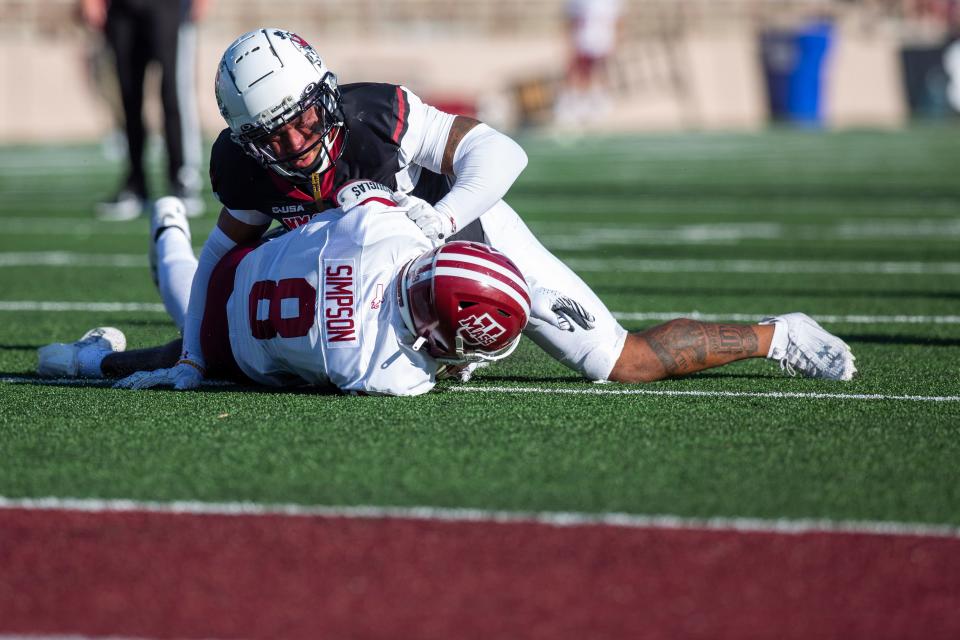NMSU's Andre Seldon tackles UMass' Keynote Glinton during an Aggie football game on Saturday, August 25, 2023, at the Aggie Memorial Stadium.