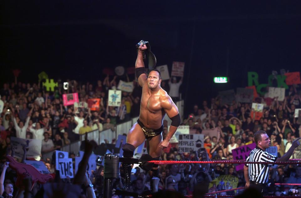 The Rock celebrates his win over Triple H on WWE's First Ever British Tour