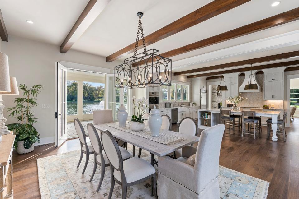 The kitchen and dining room's French doors open directly onto the screened-in porch that fronts the private pond.