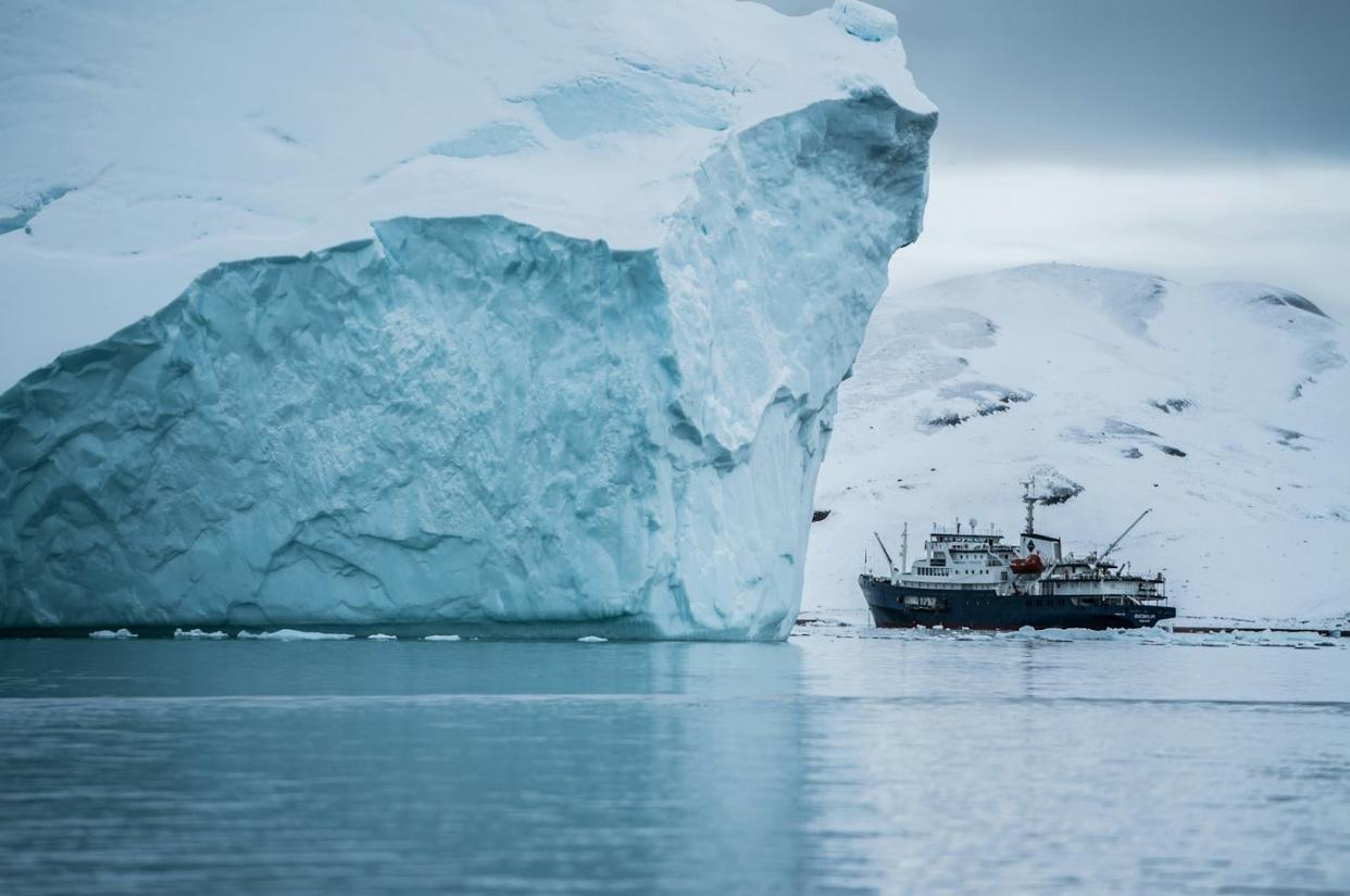 Icebergs that break off from Greenland's glaciers carry enormous amounts of fresh water that can affect Atlantic currents. <a href="https://unsplash.com/photos/boat-beside-iceberg-GG1CwF4qdlg" rel="nofollow noopener" target="_blank" data-ylk="slk:Hubert Neufeld via Unsplash;elm:context_link;itc:0;sec:content-canvas" class="link ">Hubert Neufeld via Unsplash </a>, <a href="http://creativecommons.org/licenses/by-sa/4.0/" rel="nofollow noopener" target="_blank" data-ylk="slk:CC BY-SA;elm:context_link;itc:0;sec:content-canvas" class="link ">CC BY-SA</a>