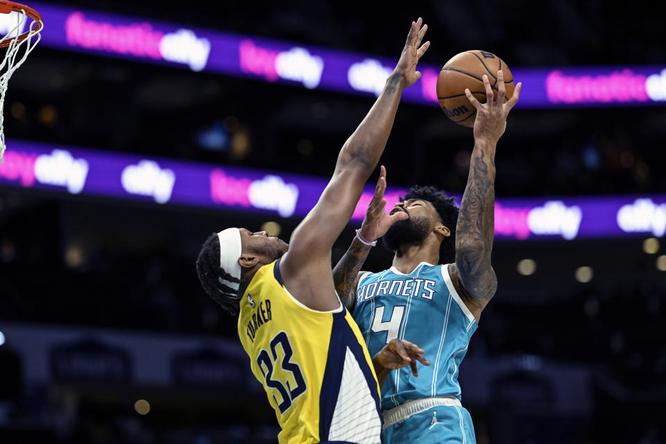 Indiana Pacers center Myles Turner (33) attempts to block a shot from Charlotte Hornets center Nick Richards (4) during the first half of an NBA basketball game, Monday, March 20, 2023, in Charlotte, N.C. (AP Photo/Matt Kelley)