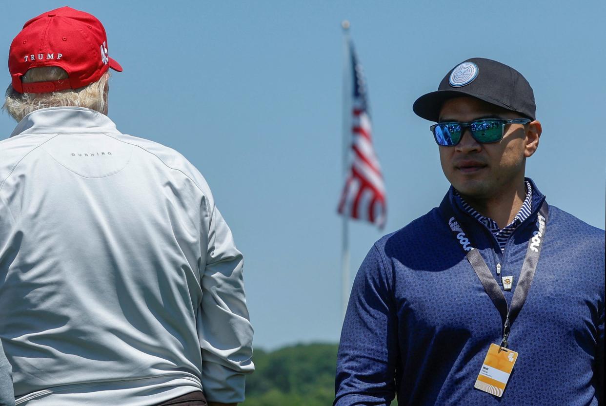 Walt Nauta, personal aide to former US President Trump, walks with him at the Trump National Golf Club in Sterling, Virginia (Reuters)