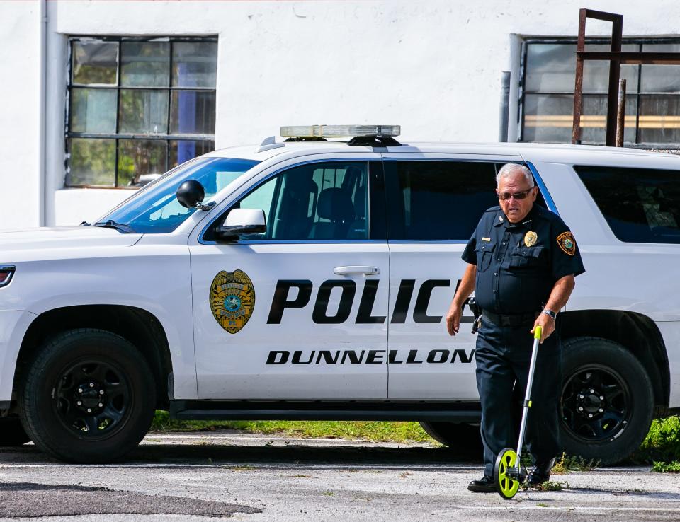 Dunnellon Police Chief Mike McQuaig measures for a temporary storage unit Thursday morning, August 12, 2021, for evidence since their evidence room as live termites in it at the Dunnellon Police Department. McQuaig wants to either improve their present building, which was built in 1926, build a new Dunnellon Police Station or renovate the Soul's Harbor Church, which the City of Dunnellon purchased for over $350,000 to move the Dunnellon Police Station into.  [Doug Engle/Ocala Star Banner]2021