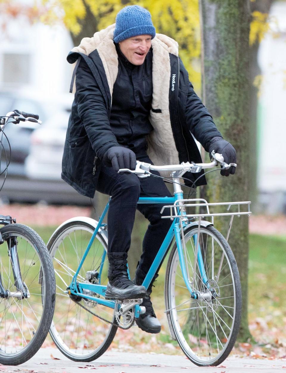 <p>Woody Harrelson bundles up as he rides a bike to the set of <i>The Man from Toronto </i>on Monday in Toronto. </p>