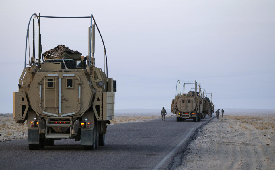 Soldiers with the 3rd Brigade Combat Team, 1st Cavalry Division perform a security check on their Mine Resistant Ambush Protected (MRAP) vehicles near the Kuwaiti border as part of the last U.S. military convoy to leave Iraq December 18, 2011. The last convoy of U.S. soldiers pulled out of Iraq on Sunday, ending nearly nine years of war that cost almost 4,500 American and tens of thousands of Iraqi lives and left a country still grappling with political uncertainty. REUTERS/Lucas Jackson