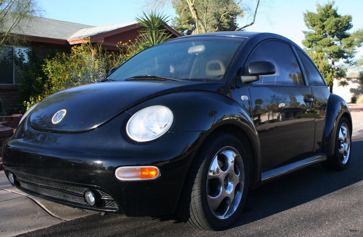 Black VW New Beetle parked on a street