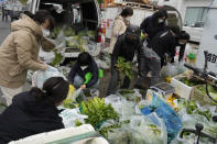 Residents buy fresh vegetables from street vendors as restaurants are closed in some districts in Beijing, Thursday, Nov. 24, 2022. China is expanding lockdowns, including in a central city where factory workers clashed this week with police, as its number of COVID-19 cases hit a daily record. (AP Photo/Ng Han Guan)