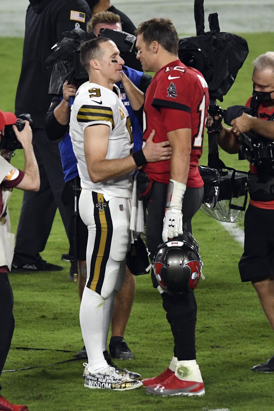 FILE - In this Nov. 8, 2020, file photo Tampa Bay Buccaneers quarterback Tom Brady (12) congratulates New Orleans Saints quarterback Drew Brees (9) after an NFL football game in Tampa, Fla. Brees, the NFL’s leader in career completions and yards passing, has decided to retire after 20 NFL seasons, including his last 15 with New Orleans. (AP Photo/Jason Behnken, File)