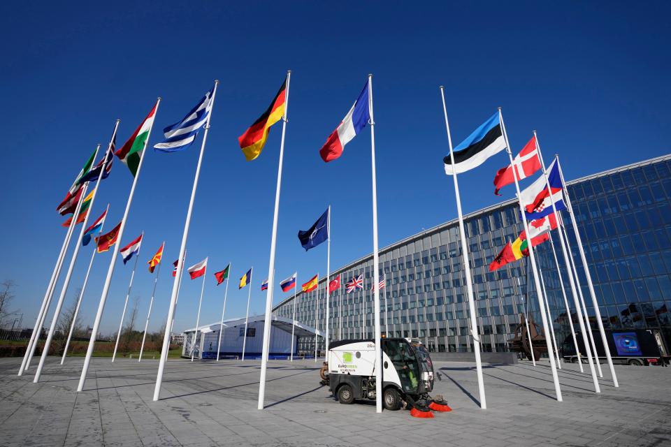 An empty flagpole stands between the national flags of France and Estonia outside NATO headquarters in Brussels, Monday, April 3, 2023. Finland awaits an official green light to become the 31st member.