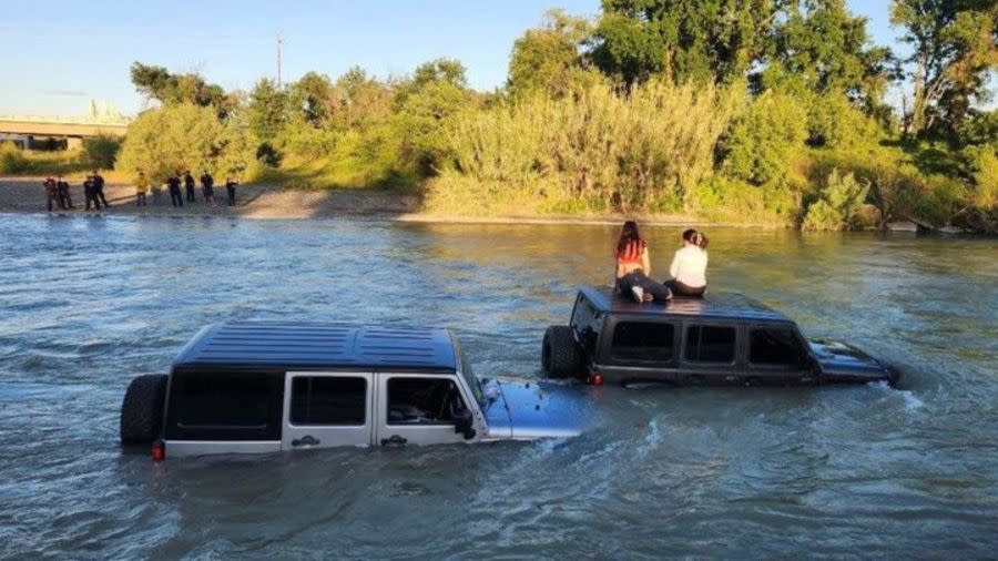 Two Jeeps stuck in a waterway
