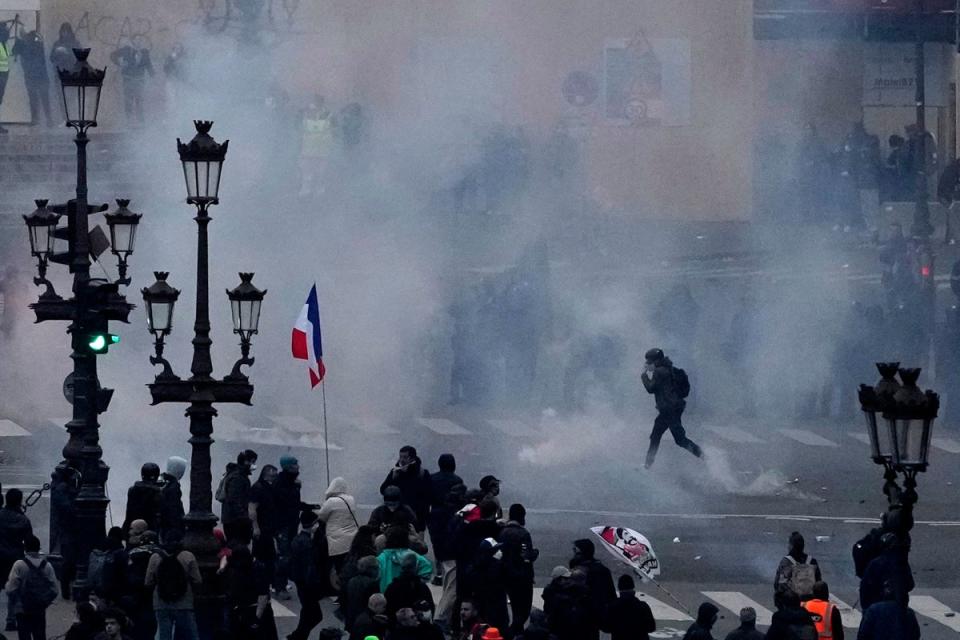 Protesters scuffle at the end of a rally in Paris on Thursday (AP Photo/Christophe Ena) (AP)