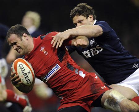 Wales' Jamie Roberts (L) scores a try against Scotland during their Six Nations Championship rugby union match at the Millennium Stadium, Cardiff, Wales, March 15, 2014. REUTERS/Rebecca Naden