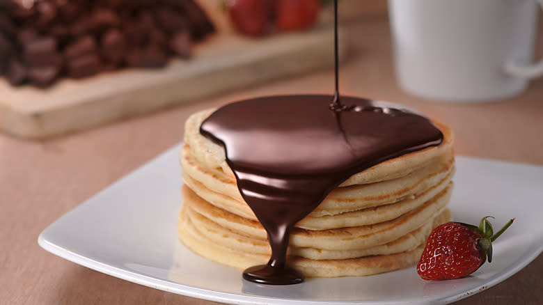 chocolate pouring on pancakes