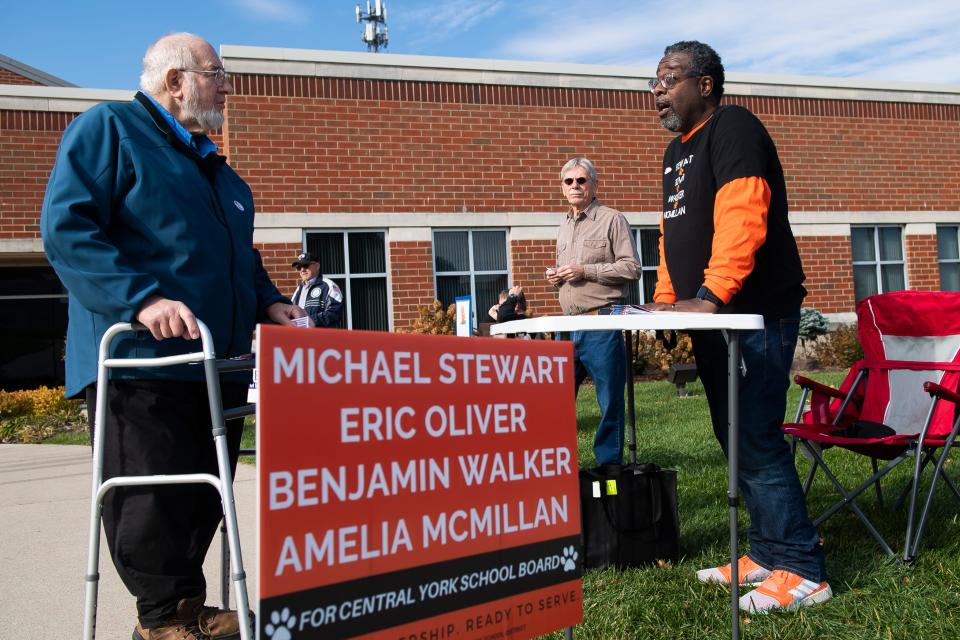 Candidate Eric Oliver (right) speaks with a voter outside the Manchester Township Municipal Building on election day, Tuesday, November 7, 2023. Oliver is one of nine candidates running for a seat on the Central York School District Board of Directors.