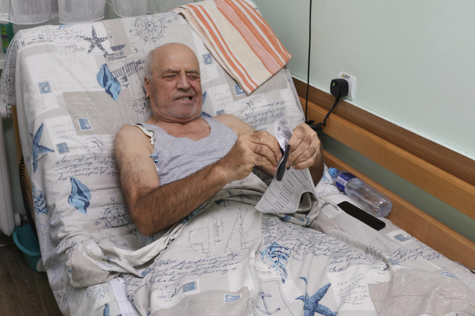 An elderly Moldovan man gestures as he stamps his ballot at a hospital during local elections, in Chisinau, Moldova, Sunday, Nov. 5, 2023. Moldovans are casting ballots in nationwide local elections amid claims by Moldovan authorities that Russia has been conducting “hybrid warfare” to undermine the vote in the European Union candidate country. (AP Photo/Aurel Obreja)